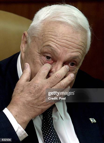 Israeli Prime Minister Ariel Sharon rubs his eye at the start of the weekly cabinet meeting June 23, 2002 in Jerusalem, Israel. Israeli forces took...