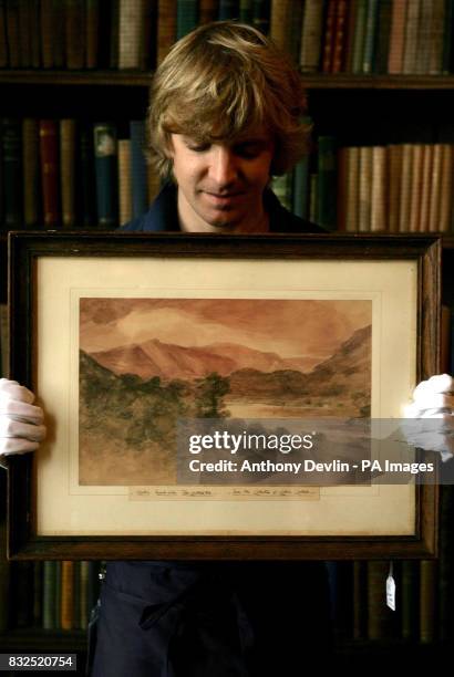 Sotherby's technician shows-off Lot 76, Looking South From Near Red Brow Towards Rosthwaite by John Constable, which is expected to fetch between...