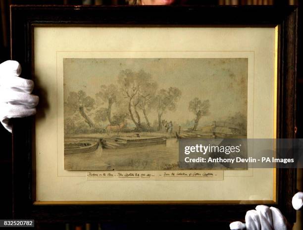 Sotherby's technician shows-off Lot 75, Barges on the River Stour at Flatford by John Constable, which is expected to fetch between 40-60 at the...