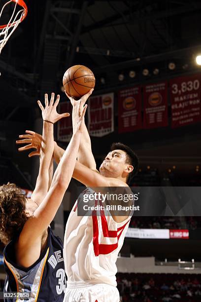 Yao Ming of the Houston Rockets goes up for a shot against Marc Gasol of the Memphis Grizzlies during a preseason game at the Toyota Center on...