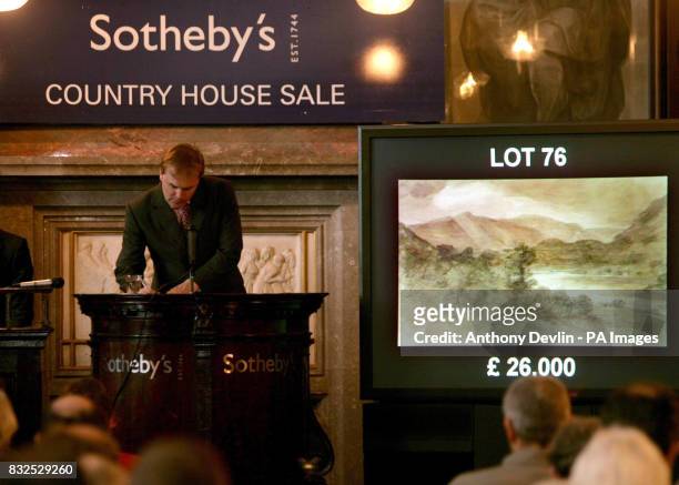 Auctioneer Harry Dalmeny accepts bids for Lot 76, Looking South From Near Red Brow Towards Rosthwaite by John Constable, which sold for 31,200 in...