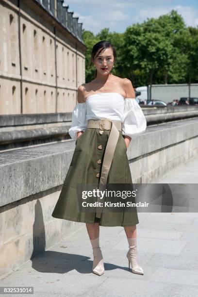 Fashion blogger Chriselle Lim wears an Exhibit top and skirt, Roberi and Fraud sunglasses with Tony Bianco boots day 2 of Paris Haute Couture Fashion...