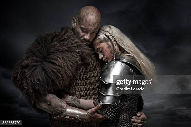 beautiful weapon wielding viking warrior couple in emotional pose - viking warrior stock pictures, royalty-free photos & images