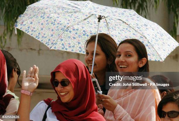 Students at the Fatima Jinnah School await the arrival of the Prince of Wales and the Duchess of Cornwall, in Rawilpindi Pakistan.