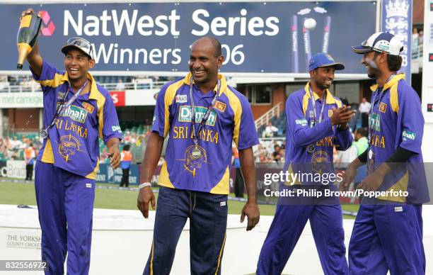 Sanath Jayasuriya of Sri Lanka celebrates with team-mate Tillakaratne Dilshan and squad members Russel Arnold and Kaushal Lokuarachchi after Sri...