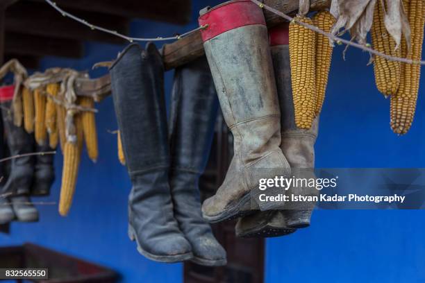 traditional old dancing boots hanging as decorations in szék, transylvania - folk stock-fotos und bilder