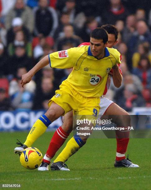 Leeds United's David Healy shields the ball from Barnsley's Paul Heckingbottom during the Coca-Cola League Championship match at Oakwell Stadium,...