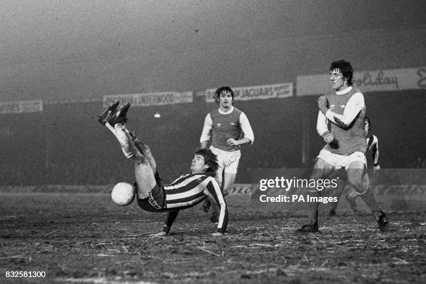 Sheffield Wednesday's Ray Blackhall fails to make contact with a spectacular scissors kick attempt as Arsenal's Pat Rice and Frank Stapleton look on