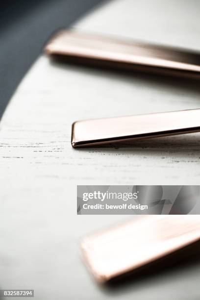 copper colored cutlery on white wooden board - besteck stock pictures, royalty-free photos & images