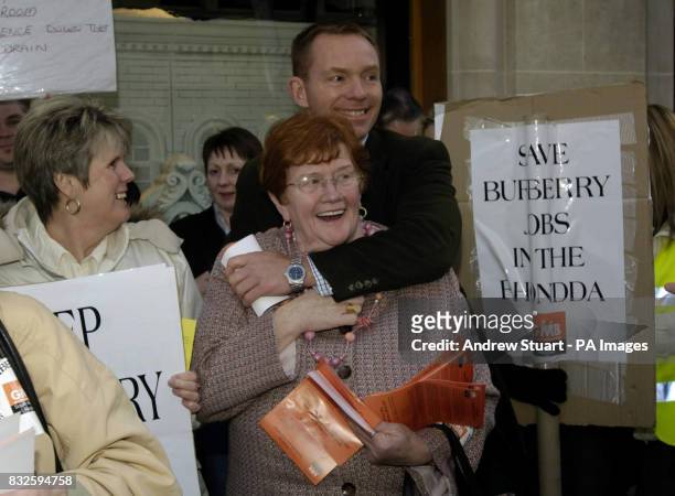 Rhonda MP Chris Bryant hugs GMB union organiser Margaret Philips workers from Burberry's factory in Wales which is due to close next year, with the...