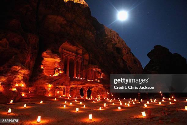 An ancient temple cut into the sandstone is lit up by candles in Petra on October 12, 2008 in Petra, Jordan. The sandstone in the region has given...