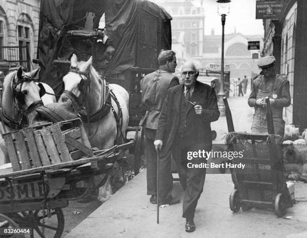 British publisher Victor Gollancz strolls through Covent Garden Market, London, on his way to his office in Henrietta Street, 18th March 1950....