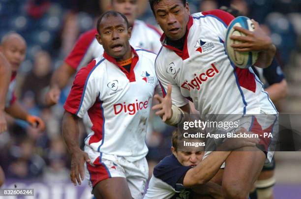 Pacific Island Epi Taione tackled by Scotland Andrew Henderson during the International match at Murrayfield, Edinburgh.