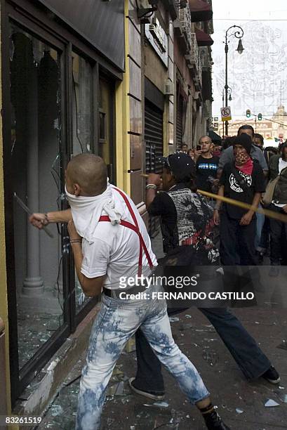 Students smash shop windows during a violent demonstration on the 40th anniversary of the massacre of Tlatelolco, at the Plaza de las Tres Culturas,...