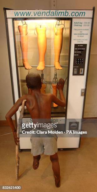 View of an Emma Heron artwork entitled 'VendaLimb' which shows a child with one leg looking into a vending machine selling artificial limbs, on...