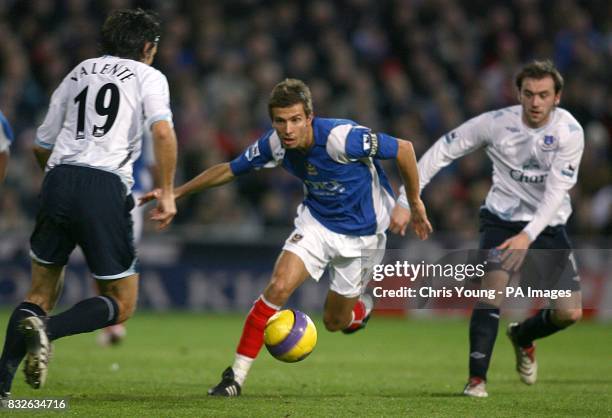 Portsmouth's Gary O'Neil charges past Everton's Jorge Nuno Valente and James McFadden