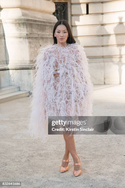 Fashion stylist Tina Leung wears a Monique L'Huillier jacket and dress with Miu Miu shoes day 2 of Paris Haute Couture Fashion Week Autumn/Winter...