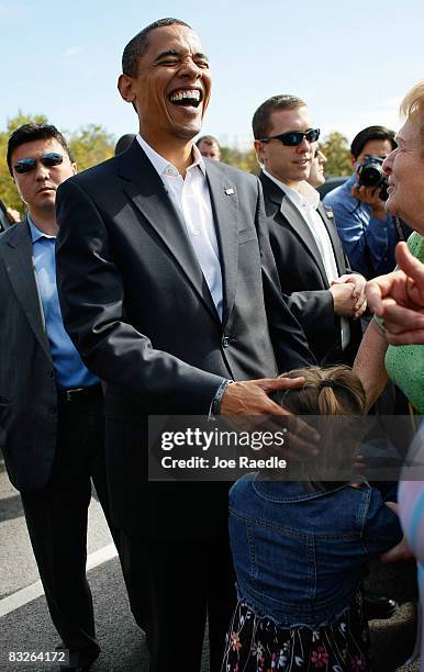 Democratic presidential nominee U.S. Sen. Barack Obama laughs with people after a young girl mistook him for Sen. John McCain when she was asked who...