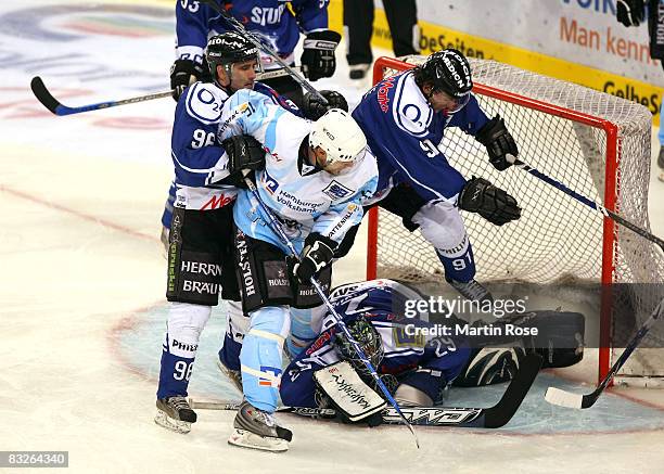 Francois Fortier of Hamburg tries to score over Glen Goodall , Jimmy Waite and Rene Roethke of Ingolstadt during the DEL match between Hamburg...