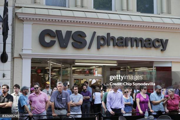 People gather outside the memorial service for Heather Heyer across from the Paramount Theater August 16, 2017 in Charlottesville, Virginia. The...