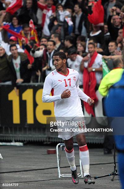 Tunisian forward Issam Jomaa reacts after scoring a goal during the friendly football match France vs Tunisia on October 14, 2008 at the Stade de...
