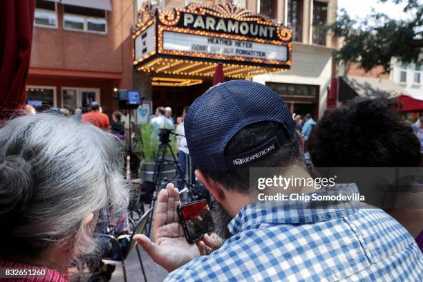 People watch a live stream of the memorial service for Heather Heyer across from the Paramount Theater August 16, 2017 in Charlottesville, Virginia....