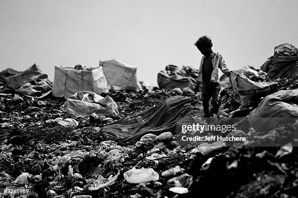 Under the shadow of the Khmer Rouge Tribunal, children and their families sift through a garbage dump to make a living March 28, 2007 in Phnom Penh,...