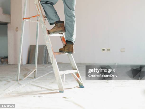 man climbing ladder in unfinished room - low section stock pictures, royalty-free photos & images