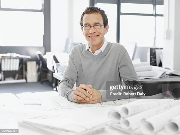 architect posing with blueprints - draft portraits stockfoto's en -beelden