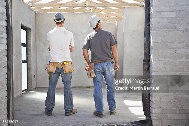 construction workers viewing construction site - tool belt stock pictures, royalty-free photos & images
