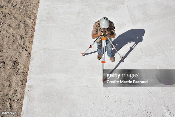 surveyor working at new construction site - theodolite stock pictures, royalty-free photos & images