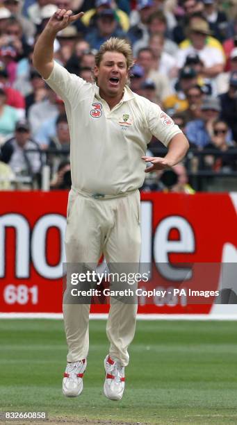 Australia's Shane Warne celebrates bowling England's Andrew Strauss to take his 700th test match wicket during the first day of the fourth Test match...