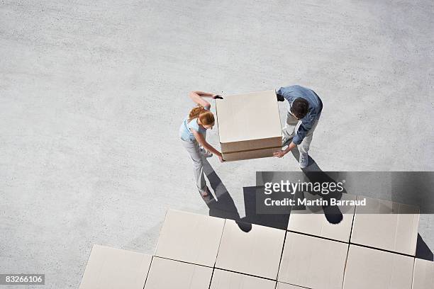couple organizing boxes - working on the move stock pictures, royalty-free photos & images