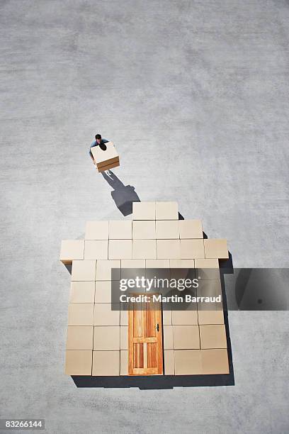 man building house outline on sidewalk - cardboard box top view stock pictures, royalty-free photos & images