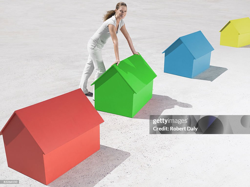 Woman standing with small model houses