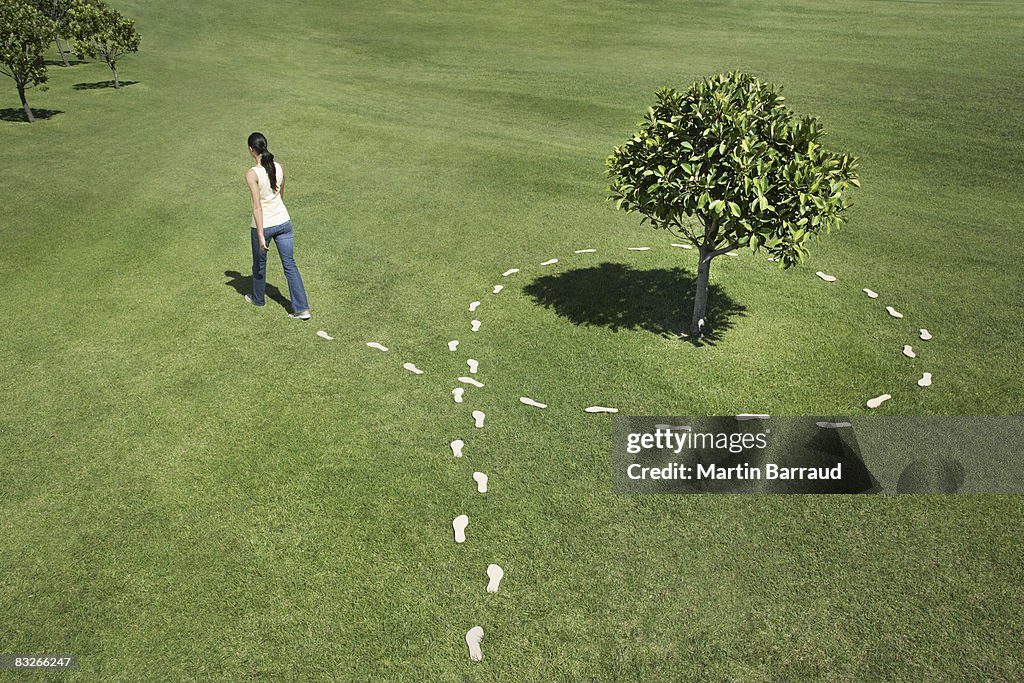 Woman walking leaving trail of footprints