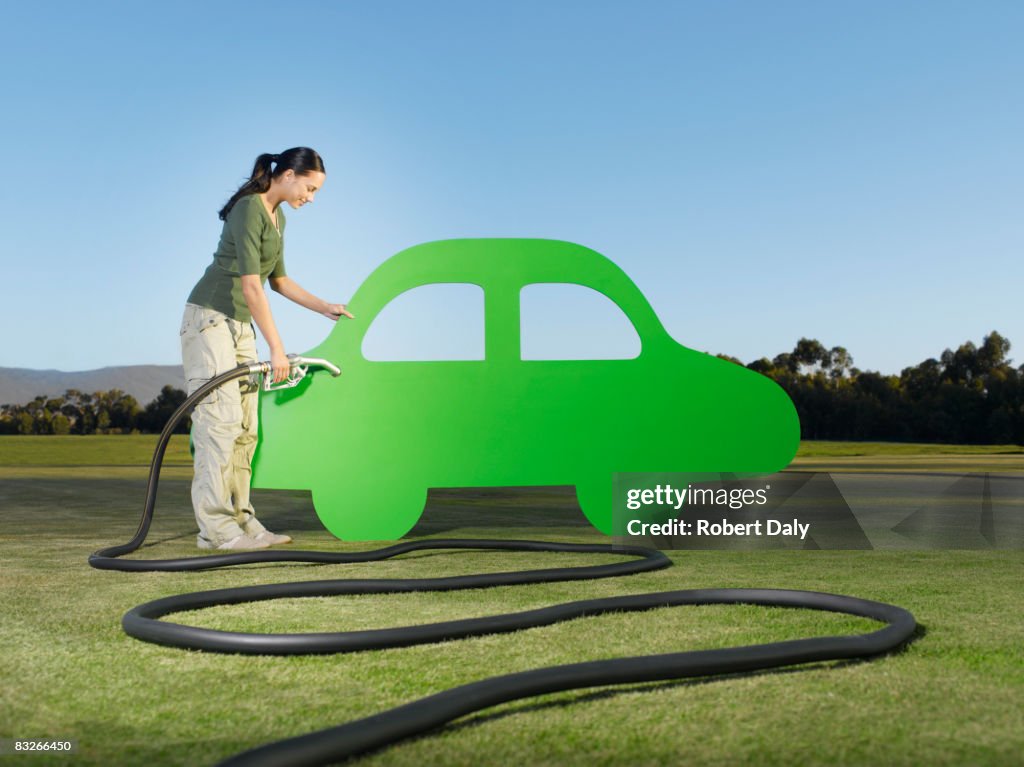 Woman refueling cutout car