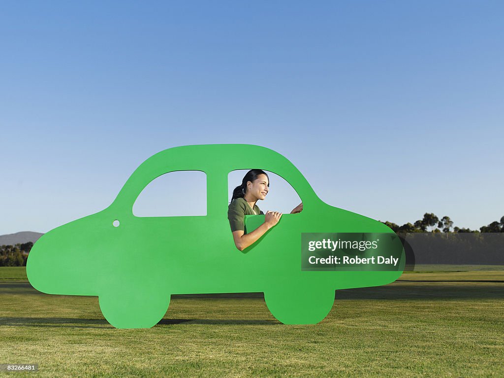 Woman driving cutout car