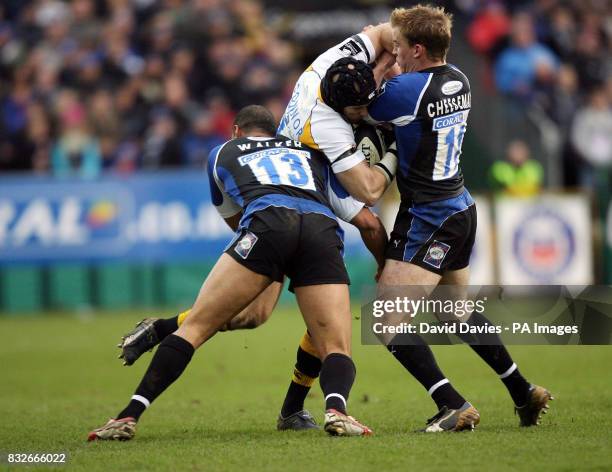 Wasps' Jonny O'Connor is tackled by Bath's Chev Walker and Tom Cheeseman during the Guiness Premiership match at the Recreation Ground, Bath.