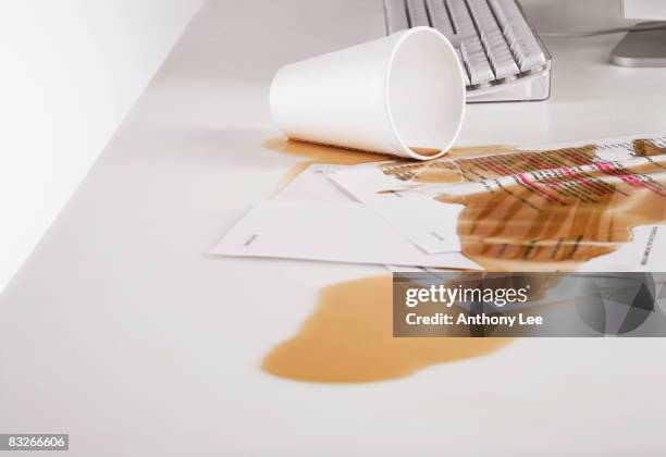 close up of coffee spilled on paperwork - coffee spill stock pictures, royalty-free photos & images