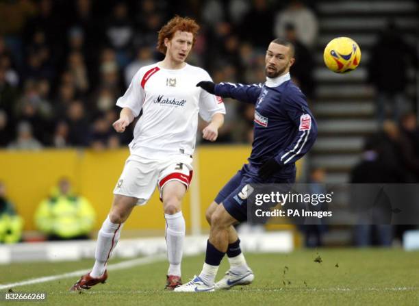 Dons' Dean Lewington challenges Swindon's Christian Roberts during the Coca-Cola League Two match at the National Hockey Stadium, Milton Keynes.