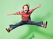 Young boy jumping in mid-air