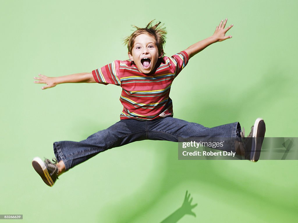 Young boy jumping in mid-air
