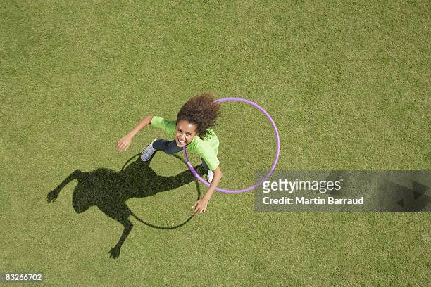 young girl playing with hula hoop - overhead view stock pictures, royalty-free photos & images
