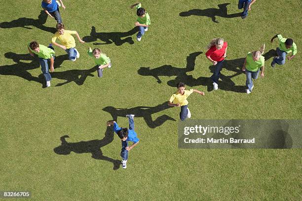 group of children running - large group of people field stock pictures, royalty-free photos & images