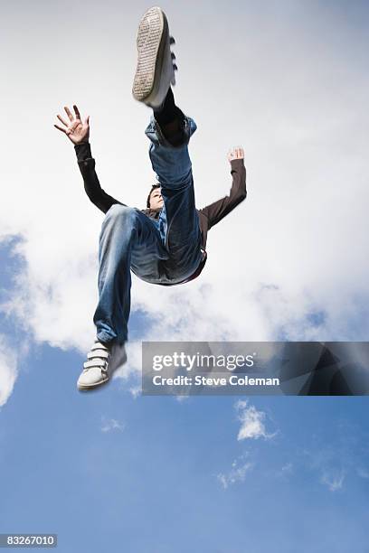 teenage boy jumping in mid-air - low angle view shoe stock pictures, royalty-free photos & images