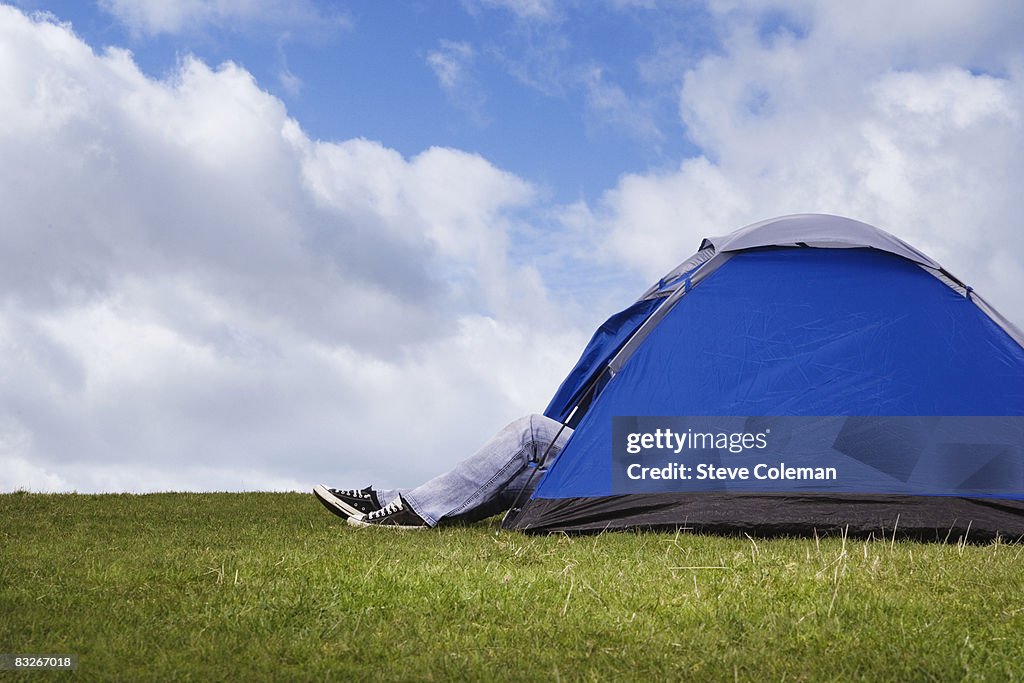 Teenage girl's legs sticking out of tent