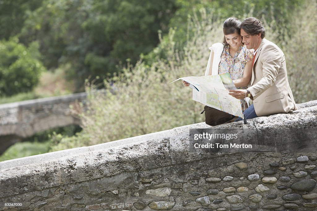 Couple looking at map outdoors