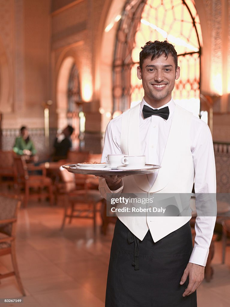 Waiter in exotic cafe