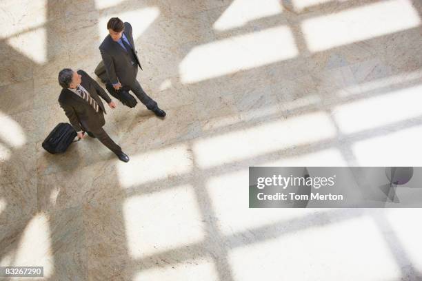 businessmen pulling rolling suitcases - overhead business shadows stock pictures, royalty-free photos & images